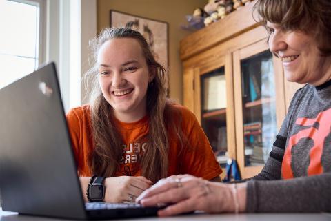 student on laptop with instructor